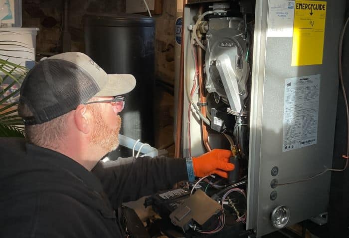 Climate Plus Technician Inspecting Heating System