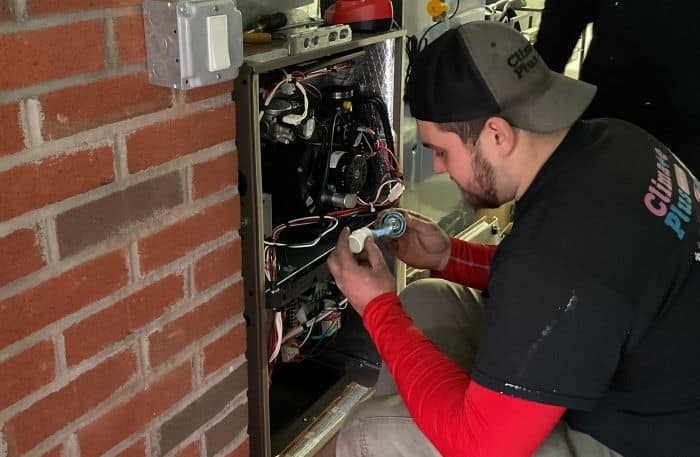 Climate Plus Technician Repairing Heating System